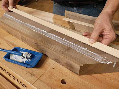 Gluing inlay strips into walnut coffee table pieces