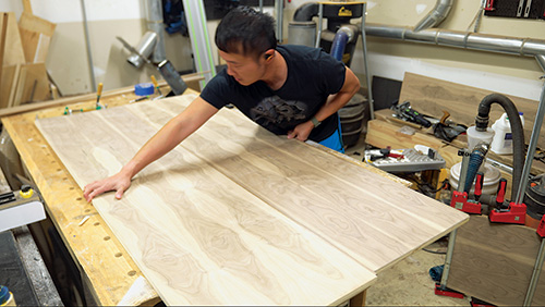 Lining up top and bottom panels of walnut cabinet